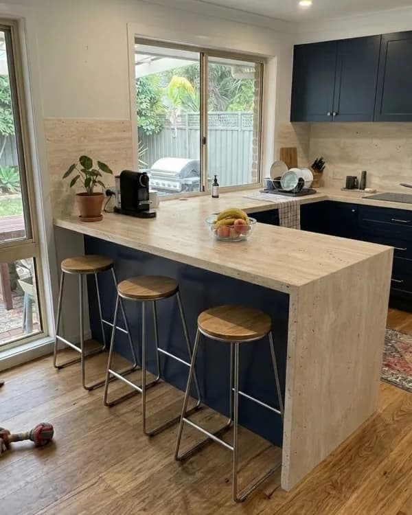 The same kitchen rendered in the customer's chosen stone — benchtop, waterfall edge, and splashback swapped